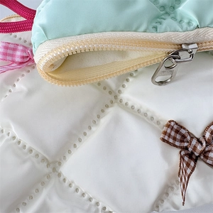 Detail of the pearlescent quilted fabric and high-quality zipper on this bow cosmetic bag