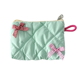 Mint green quilted lipstick bag with plaid bows and silver zipper on white background