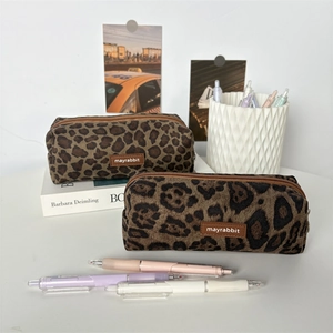 Detail of leopard print suede pencil cases with texture and leather logo on books