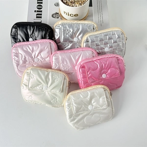 Detailed top view of quilted PU coin purses in various colors with metallic finish