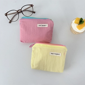 Waterproof nylon mini plaid organizer pouch in pink and yellow with label detail
