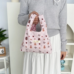 Detail of pink quilted tote bag with cute cartoon bears and mayrabbit woven label