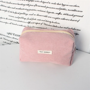 Detail of pink corduroy pencil pouch with silver ring zipper and May Rabbit label