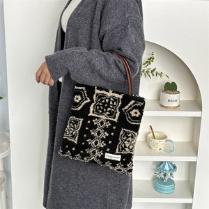 Close-up of the vintage geometric pattern and brand label on a plush tote bag