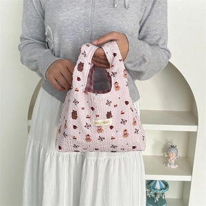 Detailed shot of pink quilted bubble tote bag with cute bear patterns and plaid lining
