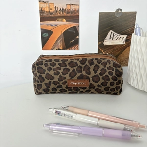 Close-up of leopard print pencil case with brown zipper and mayrabbit logo label