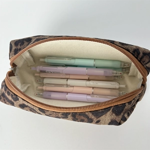 Internal view of a leopard print pencil case showing large capacity and white canvas lining