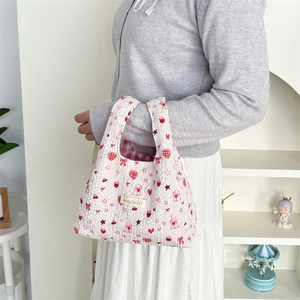 Quilted tote bag with red heart and strawberry prints for daily commute use