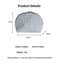 Detail of blue plaid cotton makeup bag showing dimensions 22x15x10cm and dual zippers