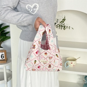 Detail of quilted bubble cotton tote bag with floral print and cute cartoon animal patterns