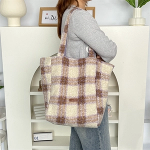 Detail view of the plush plaid tote bag showing its large capacity and soft faux fur texture