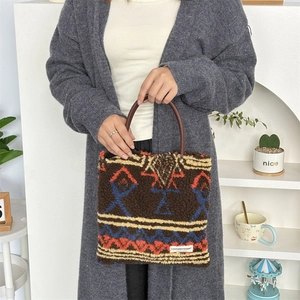 Detail of plush tote bag with ethnic patterns and comfortable round handles