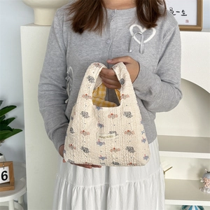 Detailed view of bubble embossed fabric handbag with cute elephant pattern and plaid lining