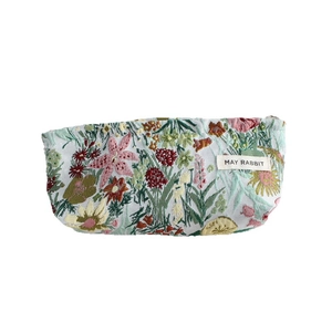 Floral embroidered canvas makeup bag with small botanical pattern and secure zipper