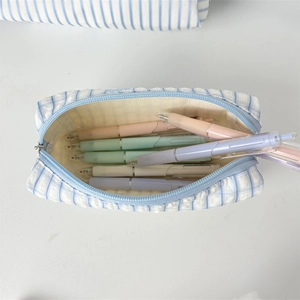 Interior view of striped fabric pencil case showing large storage capacity for pens