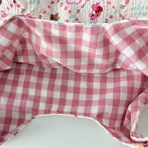 Detail view of the quilted floral bag interior with pink checkered lining and My Rabbit logo