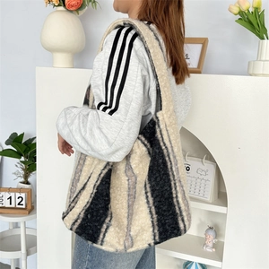 Detail of plush striped tote bag showing soft faux fur texture and spacious capacity