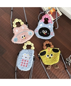 Set of four cute plush cartoon crossbody bags in assorted pastel colors on wood background