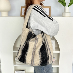 Detail of soft plush tote bag featuring black and white vertical stripes and large capacity