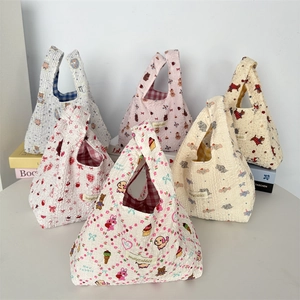 Close-up of quilted bubble puff handbags with cute animal patterns and woven brand labels