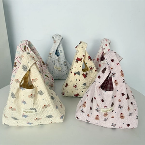 Close-up of quilted bubble fabric handbags with cute cartoon prints and Mayrabbit label