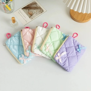 Five-piece set of quilted macaron makeup bags with silk bows and zipper closure