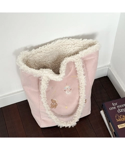Detail of pink faux suede tote with plush lamb wool lining and cute winter embroidery