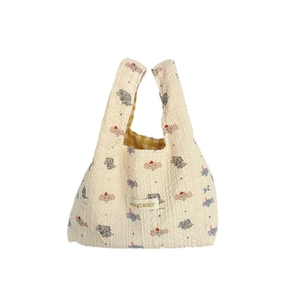 Quilted elephant print tote bag in cream white with embossed texture and top handles
