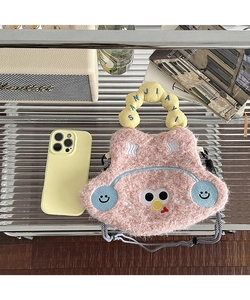 Detail of pink plush cartoon crossbody bag with yellow handle and stylish rope strap