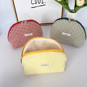 Three-piece checkered shell cosmetic bags in red, green, and yellow with zip closure