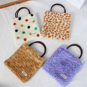 Detail view of four stylish faux fur handbags with animal prints and polka dots