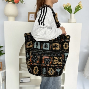 Close-up of plush tote bag with geometric plant patterns and a brand label detail