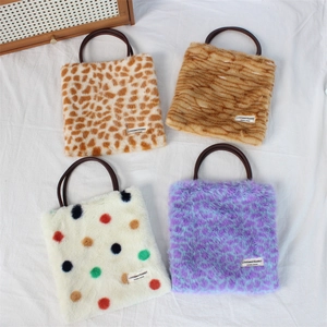 Detailed top view of four faux fur tote bags in leopard, tiger, and rainbow dot patterns