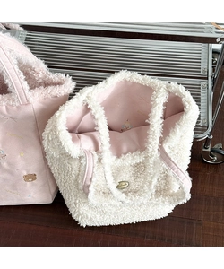 Detail of plush tote bag showing pink faux fur texture and cute bear embroidery