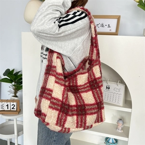 Detail of red and white checkered plush tote bag with thick soft lamb wool texture