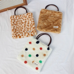 Three plush winter handbags in leopard, striped, and polka dot faux fur with curved handles