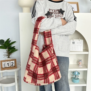 Detail of red and cream checkered plush tote bag in soft faux shearling material