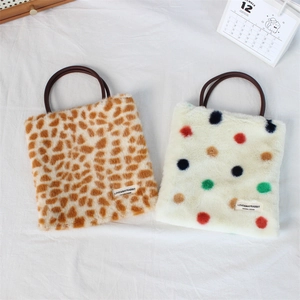 Close-up of plush handbags featuring giraffe and colorful polka dot faux fur textures