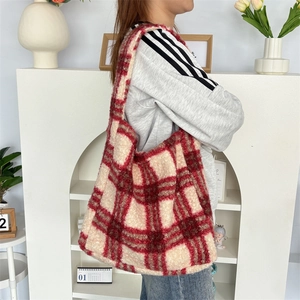 Detail of red and white checkered plush tote bag with soft faux fur texture for autumn