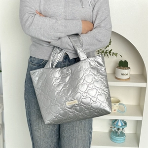 Chic metallic silver tote bag with heart-shaped quilted texture for women