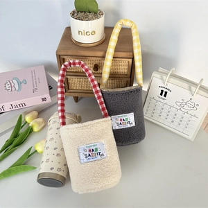 Cute plush tumbler carrier bag with checkered handle and decorative MA RABBIT label