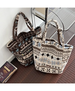 Detail of Nordic jacquard reindeer pattern on a plush fleece tote bag for autumn