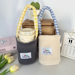 Cute plush water bottle holder with checkered handles and cartoon rabbit patch detail