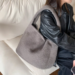 Detailed texture of gray plush faux fur tote bag showing thick and soft autumn fabric