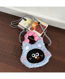 Detail of blue plush cat phone bag with embroidered handles and woven rope strap