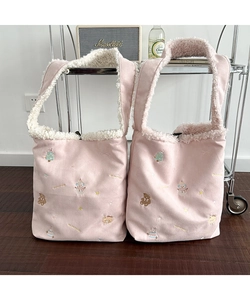 Close-up of pink suede tote bags with lamb wool lining and cute Christmas embroidery