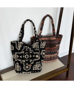 Detail showing plush tote bags with vintage patterns and branded leather label