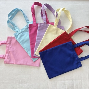 Thick solid color canvas tote bags shown in seven various colors on white background
