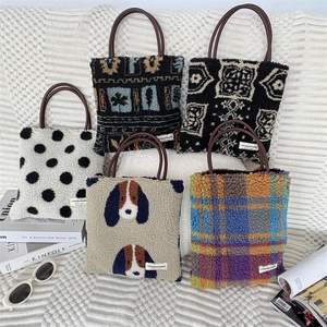 Collection of plush tote bags in various prints with round leather handles and soft textures