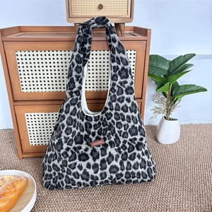 Detail van de luipaardprint tote bag van imitatiebont met bruin leren logo-label